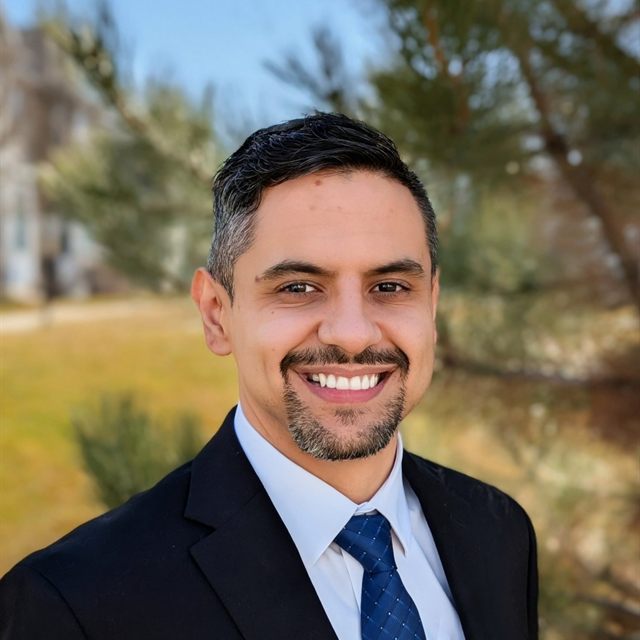 Alan Jimenez smiling in a professional portrait